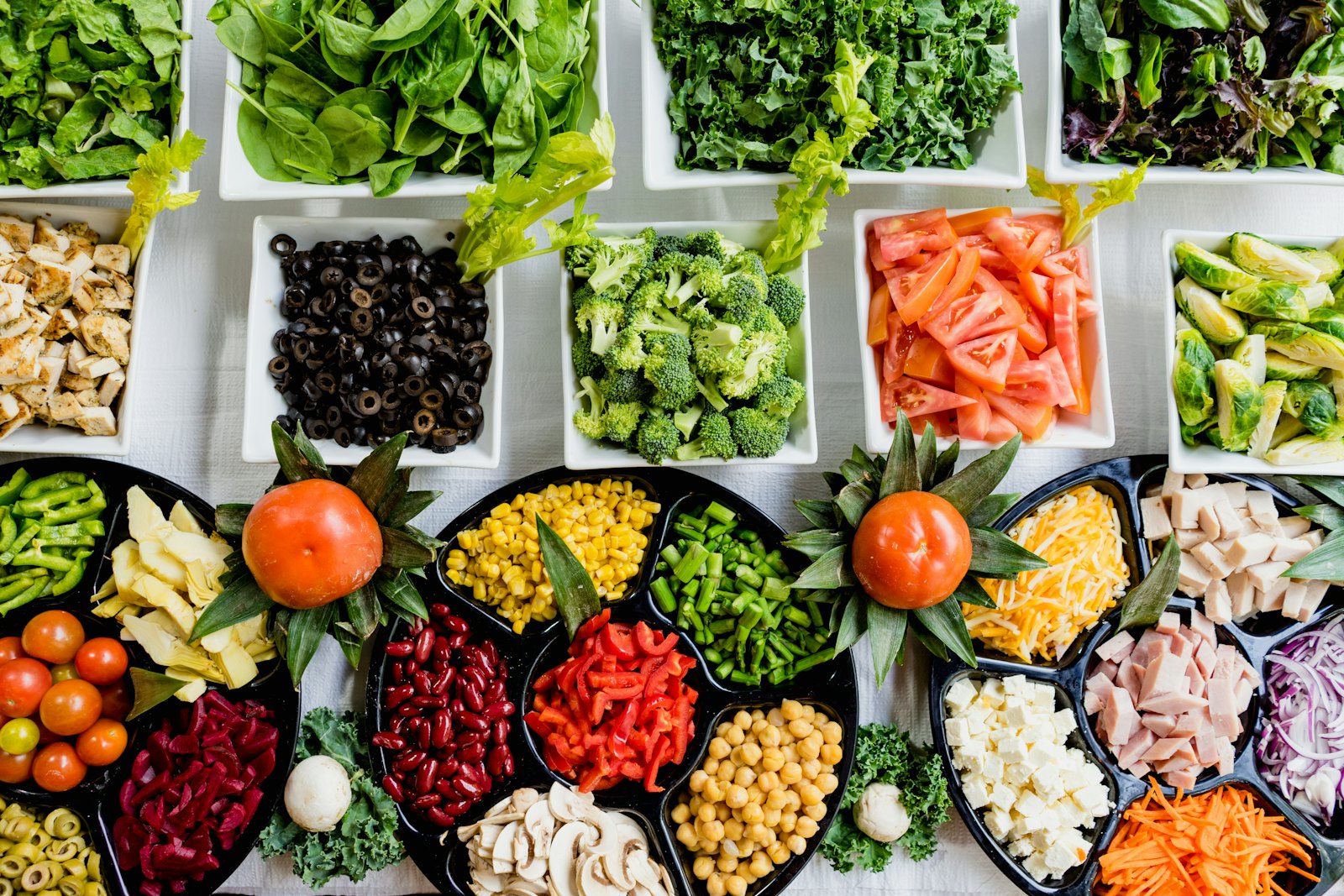 Salad bar of fresh vegetables in bowls